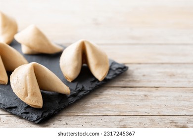 Traditional fortune cookies on wooden table. Copy space - Shutterstock ID 2317245367