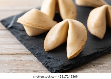 Traditional fortune cookies on wooden table - Shutterstock ID 2317245369