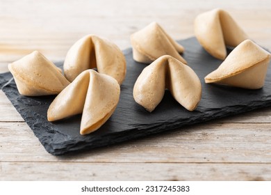 Traditional fortune cookies on wooden table - Shutterstock ID 2317245383