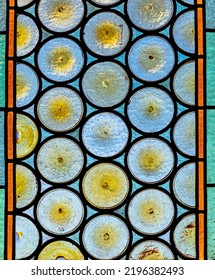 Traditional French Chateau Window Made Of Circular Tinted Glass Forming An Interesting Pattern And Texture Suitable For Backgrounds Or Wallpapers