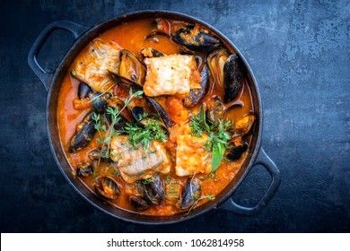 Traditional French Corsican fish stew with mussels as top view in a pot with copy space 