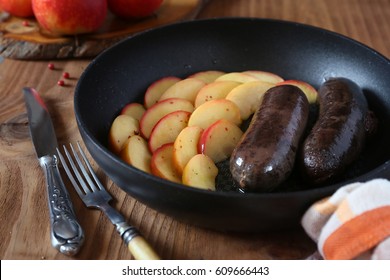 Traditional French cuisine: fried blood sausage and apples 