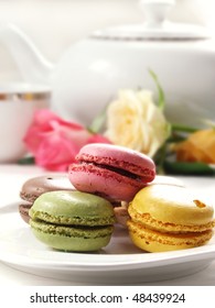 Traditional French Macarons With Tea Set On The Background