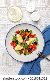 Traditional French Salad With Anchovy, Green Beans, Tomatoes, Eggs, Black Olives, Capers On White Plate And White Wooden Background. Healthy Food, No Carb Diet Concept. 