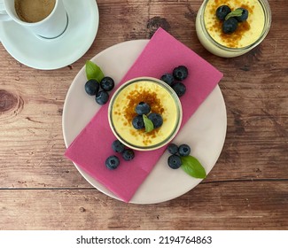 Crème Brûlée, Traditional French Vanilla Cream Dessert With A Caramel Crust, And Served With Blueberries.