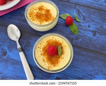 Crème Brûlée, Traditional French Vanilla Cream Dessert With A Caramel Crust, And Served With Raspberries.