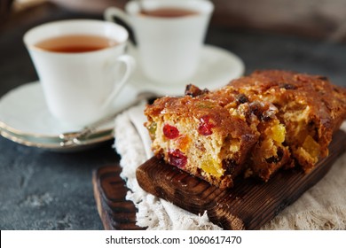 Traditional fruit cake pudding with dried fruits on wooden board copy space