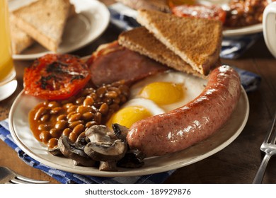 Traditional Full English Breakfast With Eggs, Bacon, Sausage, And Baked Beans