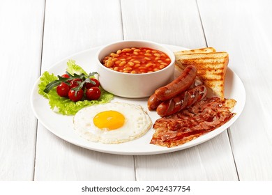 Traditional Full English Breakfast, On A White Background, Fried Eggs With Fried Bacon, Sausages, White Beans ,cherry Tomatoes, Horizontal, No People,