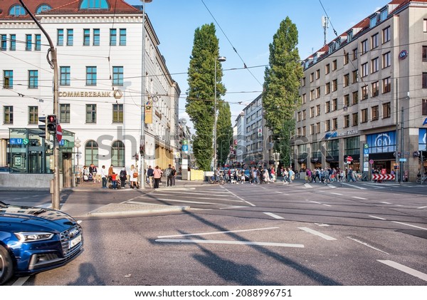 A traditional\
German city street with old houses facades, cafes and shops:\
Munich, Germany - September 12,\
2018