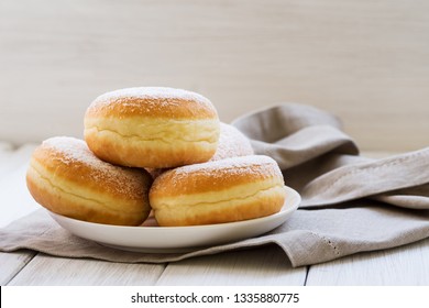 Traditional German Polish Donut with Raspberry Jam Dusted with Icing Sugar. Traditional meal on Fat Thursday, the last day of the carnival.
