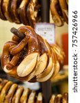 Traditional German pretzels hanging on a stand for sale