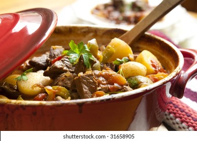 Traditional Goulash Or Beef Stew, In Red Crock Pot, Ready To Serve.  Shallow DOF.