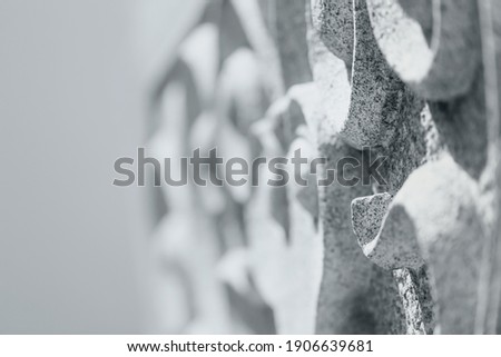 Traditional granite stone curve sculpture.Oriental style in
monochrome for background,very shallow depth of field and selective focus.