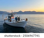 Traditional greek fishing boat with fighing nets in the aegean sea, Greece.