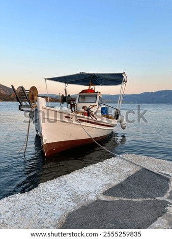 Traditional greek fishing boat with fighing nets in the aegean sea, Greece.