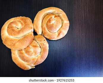 Traditional Greek Pastries. Snail With Meat Or Cheese. Roll With Filling On A Wooden Rustic .