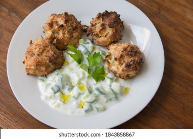 Traditional Greek Patties, Made Of Leek And Cheese, Served With Tzatziki Sauce In A Plate