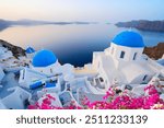 traditional greek village Oia of Santorini, with blue domes of churches and village roofs, Greece