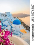 traditional greek village Oia of Santorini, with blue domes of churches and village roofs, Greece