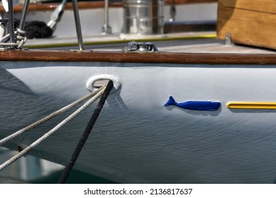 Traditional Greek Wooden Fishing Boat Port Side With Anchor Hole And Ropes.