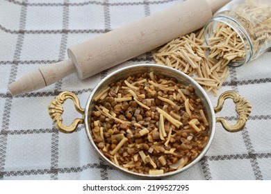 Traditional green lentil noodle dish. Traditional dish of Turkish cuisine. With noodles and rolling pin on kitchen cover. - Shutterstock ID 2199527295