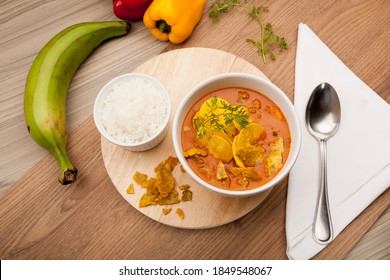 Traditional Green Plantain Soup Or Patacones, Accompanied By A Portion Of White Rice