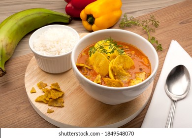 Traditional Green Plantain Soup Or Patacones, Accompanied By A Portion Of White Rice