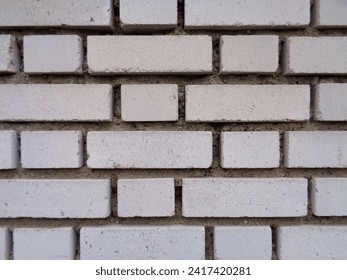 Traditional grey bricks with small empty spaces inbetween background 