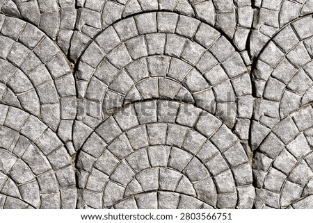 Traditional grey cobblestone pavement pattern in semicircle design background
