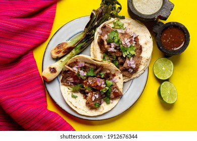 Traditional grilled beef steak tacos on yellow background. Mexican food