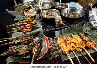 Traditional Grilled Fish And Chicken Sticks. Street Food, Laos.