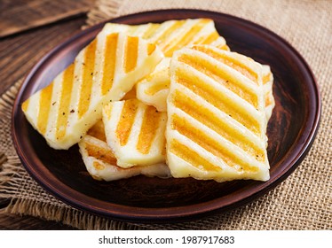 Traditional Grilled Halloumi Cheese On Plate On Wooden Background.