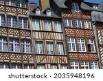 Traditional half-timbered buildings in the old town of Rennes - Brittany, France. These facades are a popular tourist attraction in Place du Champ-Jacquet.