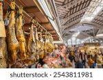 Traditional hamon shop in Central Market of Valencia, jamon iberico in the Mercat Central. Black leg pork, traditional national Spanish meat in store. Selective focus