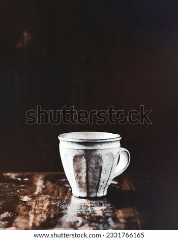 Similar – A painted ceramic milk jug next to an empty white cup