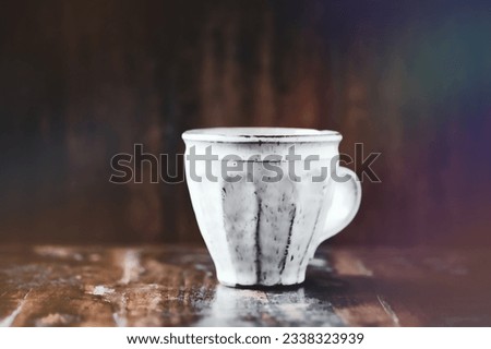 Similar – A painted ceramic milk jug next to an empty white cup