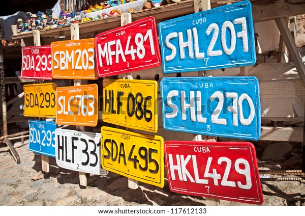 Traditional handcrafted vehicle\
registration plates like souvenirs for sale in Trinidad,\
Cuba.