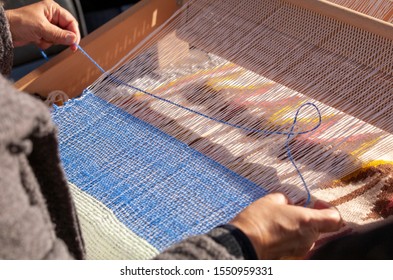 A traditional hand-weaving loom being used to make cloth