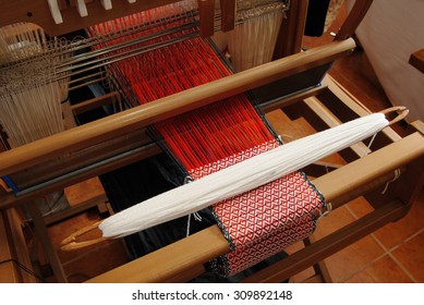 A traditional hand-weaving loom being used to make cloth 