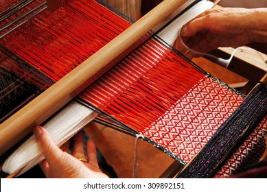 A traditional hand-weaving loom being used to make cloth  - Shutterstock ID 309892151