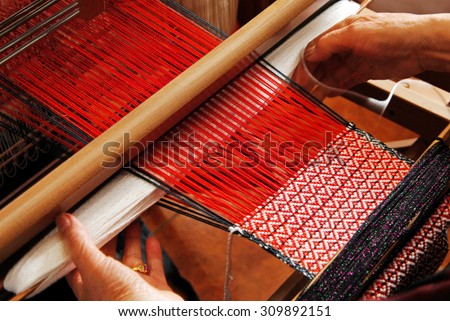A traditional hand-weaving loom being used to make cloth 