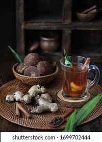A traditional herbal spices drink known as bandreks in indonesia. It consist of ginger, cinnamon, clove, pandan leaf and brown sugar. It has  a good smell and bown  colour. 