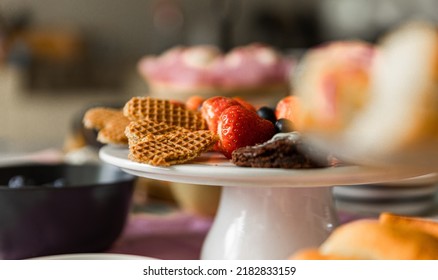 Traditional High Tea With Different Kind Of Cakes And Sweet Treats. Blueberries, Cake, Macarons, Strawberries And More. 