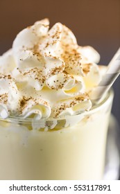 Traditional Holiday Drink Egg Nog Garnished With Whipped Cream In The Glass.