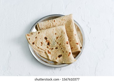 Traditional home made Chapati, Phooli, Roti, Fulka Indian bread Rajasthan India. Folded flatbread whole wheat Chapathi, Chapatti, Chappathi. popular side dish chilly chicken, butter chicken, Dal fry.