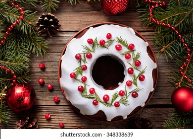 Traditional Homemade Christmas Cake Holiday Dessert With Cranberry In New Year Tree Decorations Frame On Vintage Wooden Table Background. Rustic Style. Top View