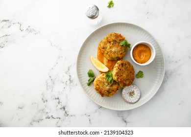 Traditional homemade fish cakes with tomato sauce