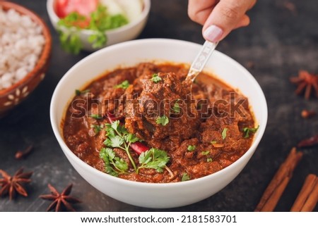 Traditional homemade Mutton curry from Asian cuisine Chukhandar gosht woman hand eating serving spicy meat beef curry coconut mutton roast Indian spices. side dish Ghee rice Appam Parotta