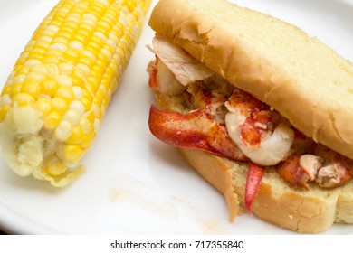 A Traditional Hot Connecticut Style Lobster Roll With Corn On The Cob On The Side.